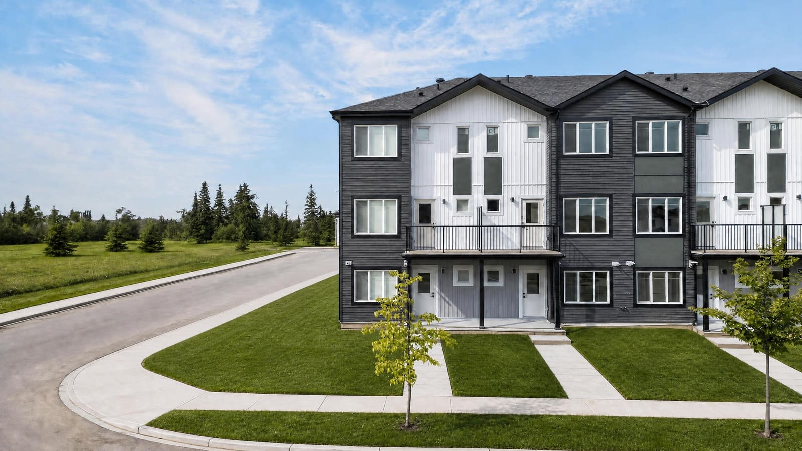 Row of finished rental homes facing a green lawn