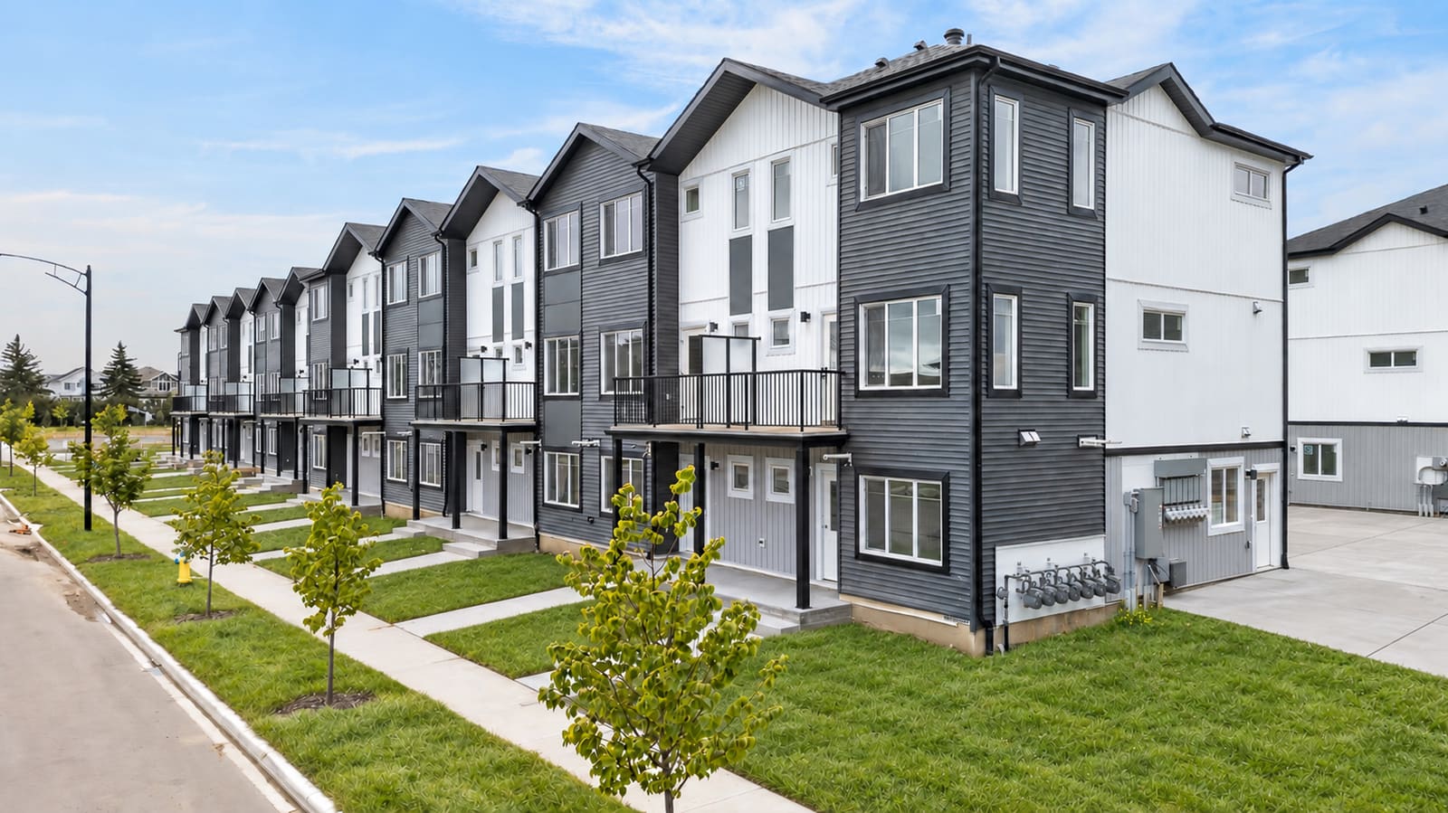 Front walkways and entries along a finished townhome row